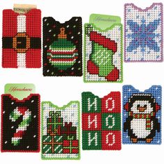 six cross stitch christmas cards with santa claus, penguin and snowflakes on them