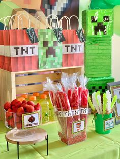 a table topped with bags filled with strawberries next to other foods and desserts