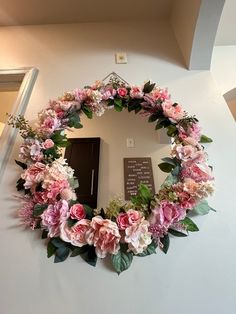 a wreath with flowers hanging on the wall