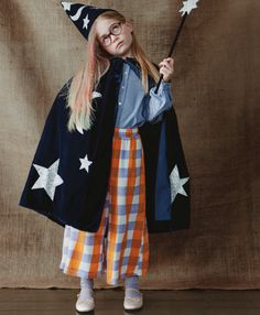 The combination of luxurious blue velvet, with silver glitter fabric stars and moons, makes this costume very special. Simply wrap around the cape, pop on the hat, and wave the star topped wand, to look like a wizard in seconds. It's perfect to wear to parties, or for imaginative play. Blue velvet cape, with silver glitter fabric moons and stars, with a cotton lining Blue velvet hat, with silver glitter fabric moons and stars The wand is topped with a silver glitter fabric star, and has a blue v Wizard Costume, Stars And Moons, Velvet Cape, Velvet Hat, Meri Meri, Fabric Stars, Witch Costume, Boy Costumes, Star Top