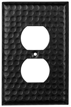 a black metal outlet cover with an oval design