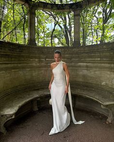 a woman in a white dress posing for a photo