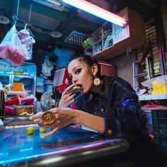 a woman sitting at a table with food in her hands