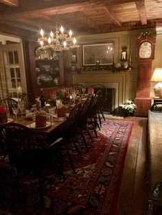 a dining room table with chairs and a rug on the floor