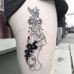 a woman's thigh with a tattoo on it