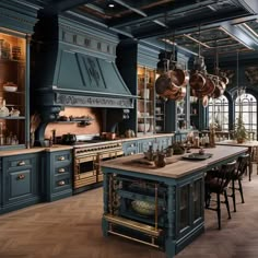 a large kitchen with blue cabinets and wooden floors is pictured in this image, there are hanging pots on the stove