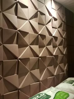 the wall is made out of cardboard and has green stickers on it's sides