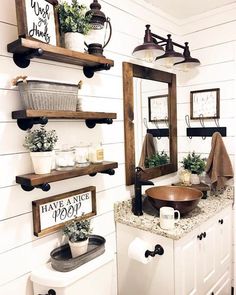 a bathroom with white walls and wooden shelves on the wall, along with an open sink