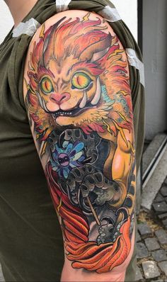 a man with a cat tattoo on his arm