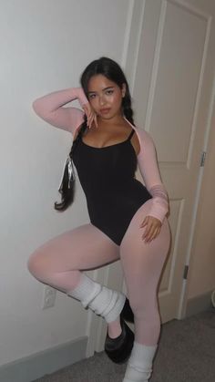 a woman is posing for the camera with her leg up and one hand on her head