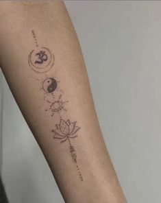 a woman's arm with tattoos on it and the sun, moon, and lotus