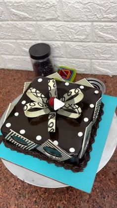 a cake that is sitting on top of a blue plate with white polka dots and a bow