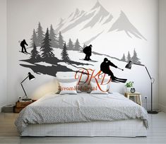 a bedroom with a mountain scene painted on the wall and skis in the foreground