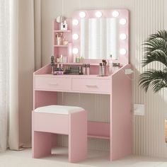 a pink vanity with lights on it and a stool in front of the mirror,