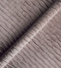 an up close shot of the textured fabric on a bed sheet that has been made