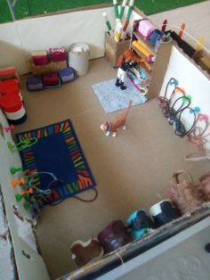 a room with many crafting supplies on the floor, including crayons and pencils