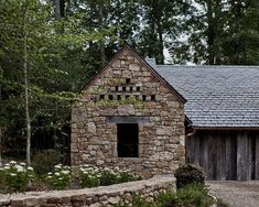 an old stone building in the woods