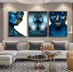 three paintings on the wall in a living room