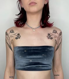 a woman with red hair and tattoos on her chest