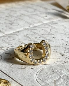 The Lucky Horseshoe Ring is here to bring you Luck! This chunky gold plated silver ring with cubic zirconia will definitely be your new favorite. About 1/2 inch in width. Horseshoe Engagement Ring, Lots Of Rings, Etsy Jewelry Rings, Silver And Gold Ring, Heart Shaped Diamond Ring, Monogram Ring