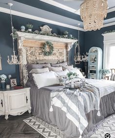 a large bed sitting in a bedroom next to a chandelier