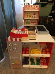 a child's play kitchen with fruits and vegetables