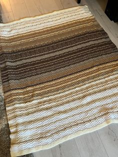 a brown and white striped rug on the floor