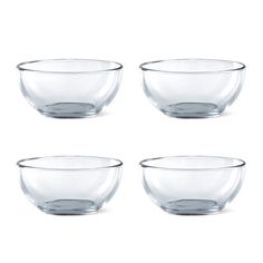 four clear glass bowls sitting next to each other