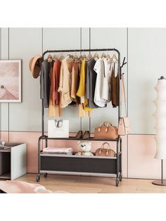 an iron rack with clothes and shoes hanging on the wall next to a lamp in a room