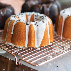 bundt cake with white icing and chocolate sprinkles on a cooling rack