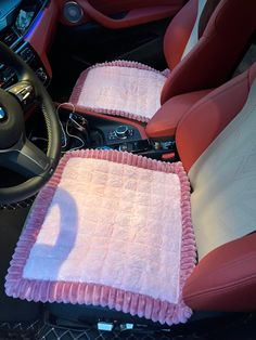 the interior of a car with pink cloths on it