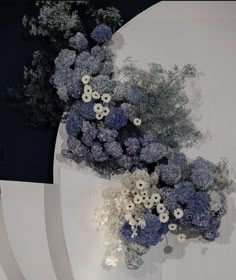 an arrangement of blue and white flowers on display