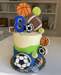 a birthday cake decorated with sports balls and numbers