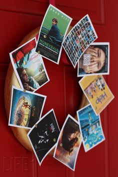 a wreath made out of various movie posters on a red door with magnets attached to it