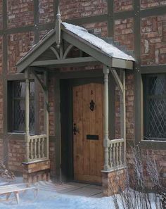 an image of a wooden door in front of a brick building with snow on the ground