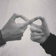 two hands making a heart shape with their fingers