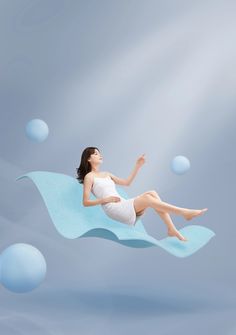 a woman is floating in the air with bubbles