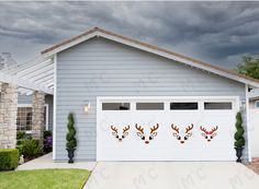 two deer heads on the side of a garage door