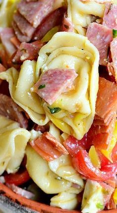 pasta salad with ham and vegetables in a bowl