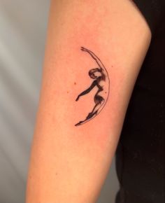 a woman's arm with a tattoo on it that has a silhouette of a person jumping in the air