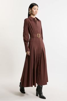 Feel Polished In Our Shirt Maxi Dress Featuring A Tailored Bodice And Pleated, Flowing Skirt. The Stylish Belted Detail Accentuates The Waist, Creating A Flattering Silhouette That Complements Every Body Type. This Maxi Dress Is An Ideal Choice For An Elevated Work Outfit And Allows You To Seamlessly Transition From Desk To Dinner With Sophistication. Formal Tailored Belted A-Line Maxi Dress Flattering Tailored Bodice Elegant Pleated Skirt Belted Detail Statement Strong Shoulders Drop Waistline Elegant Brown Shirt Dress For Daywear, Formal Brown Long Sleeve Maxi Dress, Brown Long Sleeve Maxi Dress For Formal Occasions, Elegant Long Sleeve Brown Shirt Dress, Elegant Brown Collared Midi Dress, Collared Brown Dress For Work, Formal Brown Belted Dress, Belted Brown Dress For Work, Maxi Length Belted Shirt Dress For Work