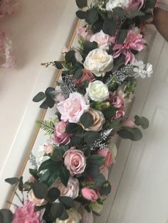 the flowers are arranged on the wall by the door way, and ready to be put into the vase