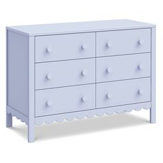 a white dresser with scalloped drawers on the top and bottom, against a white background