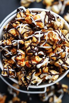 a white bowl filled with popcorn covered in chocolate