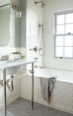 a bathroom with a sink, mirror and bathtub