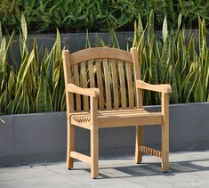 a wooden chair sitting on top of a sidewalk