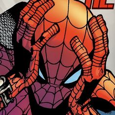 a close up of a spider man with his hands on his face