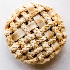 an apple pie with the words braiding pie crust video tutor on top and below it