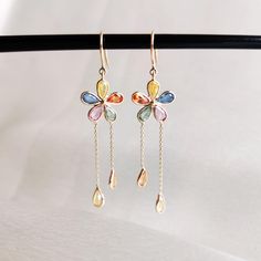 These stunning earrings are set in 14k Solid Yellow Gold with Natural Multi Sapphire with utmost precision. It is an unique and dainty gemstone earring pair for nearly every occasion and is completely hassle-free jewelry. ITEM DETAILS: * Gem: Multi Sapphire  * Gem Size: 3X4 mm (14pcs) * Gem Shape: Pear Cut * Gem Weight: 3.27 carats * Gold Purity: 14KT * Gold Weight: 1.272 gram * Total Weight of the Earrings: 1.926 gram ✔️The Gold purity is guaranteed and it comes with authentic 14KT gold hallmar Sapphire Drop Earrings, Sapphire Gem, Handmade Jewelry Box, Multi Sapphire, Birthstone Earrings, Earrings Dainty, Birthstone Earring, September Birthstone, Stunning Earrings