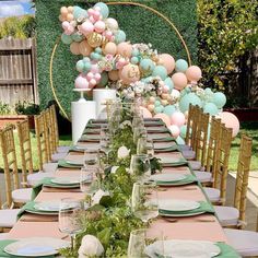 a long table with plates and place settings set for a formal dinner in the garden